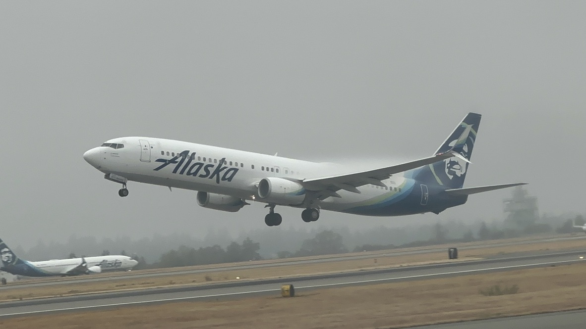 An aircraft approaching a runway through low clouds